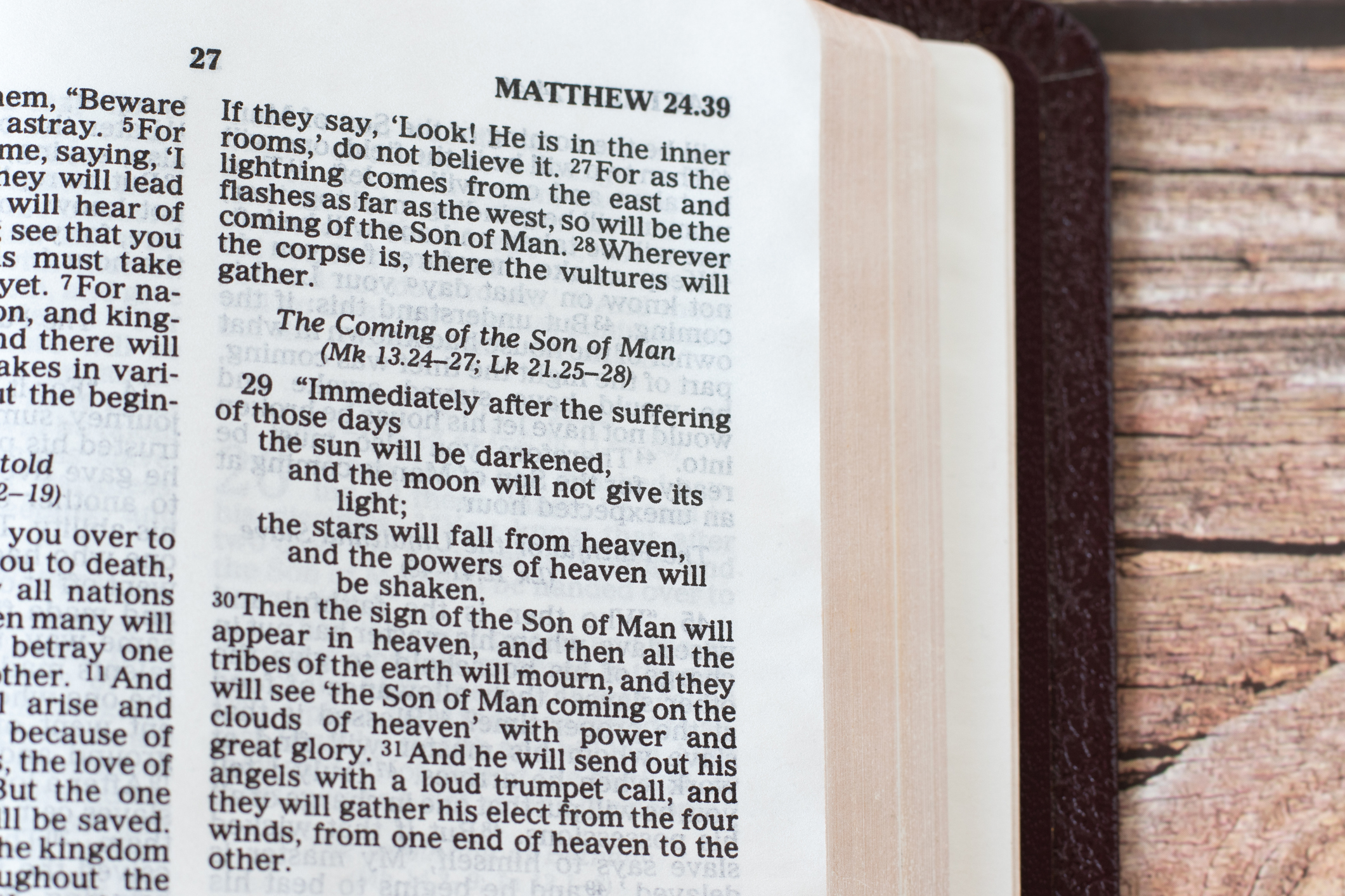 Coming of the Son of Man sign, biblical verses in an open Holy Bible Book on a wooden table. A closeup. Matthew 24 end time prophecy. Christian biblical concept.