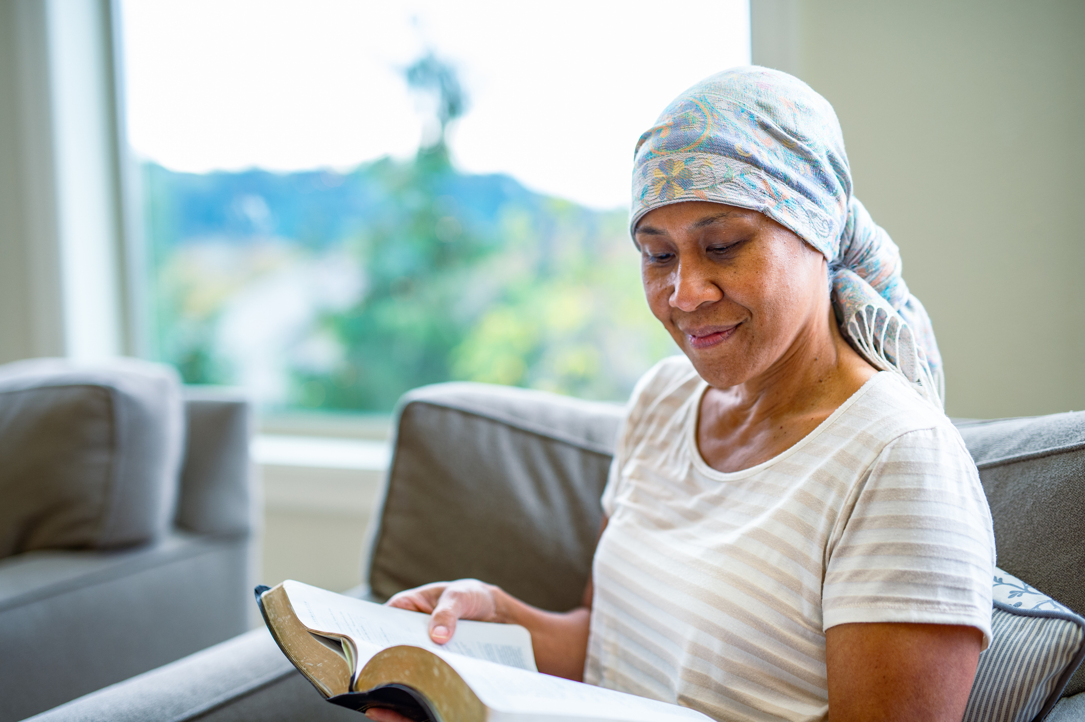 Senior woman reads at home