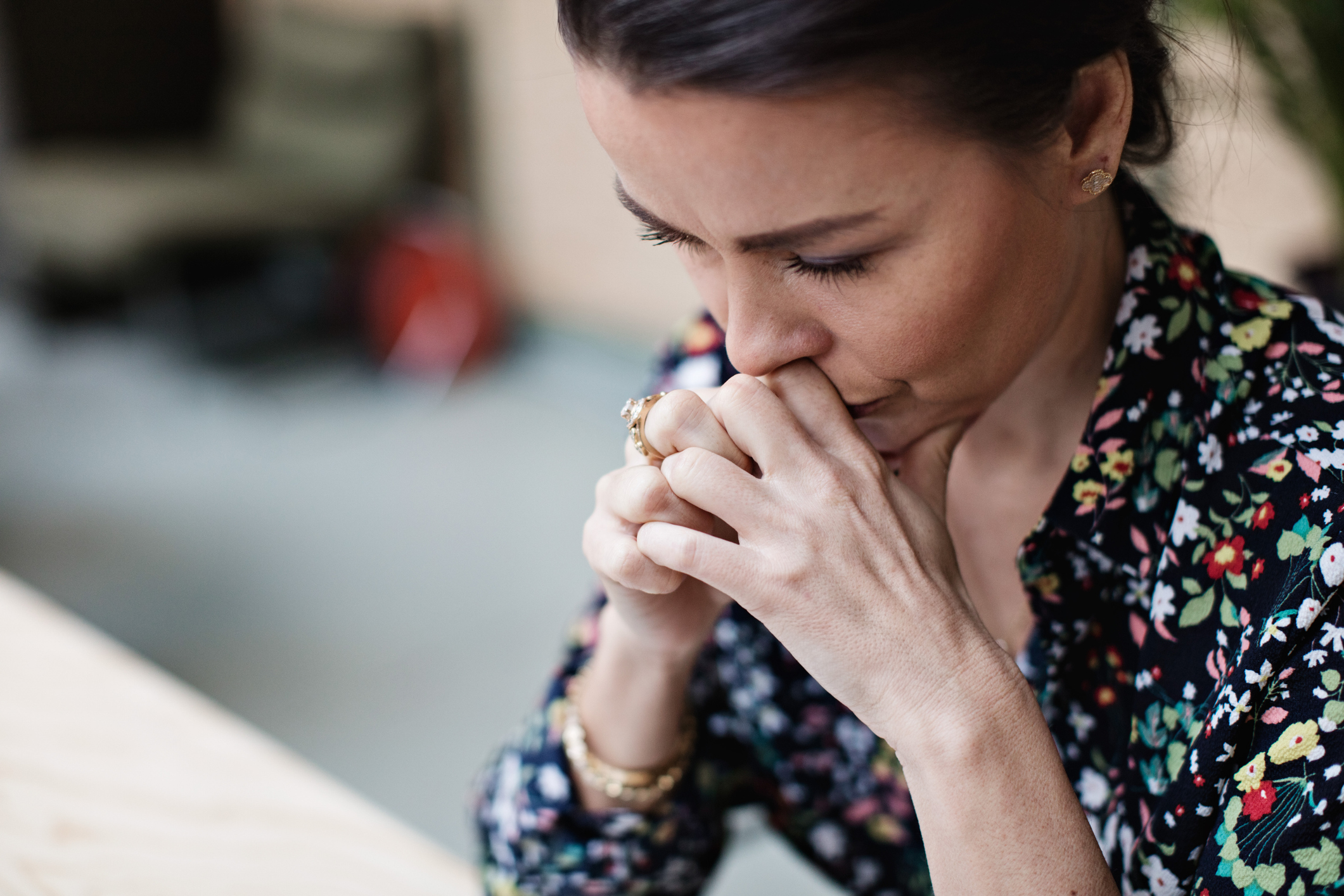 woman praying while looking down