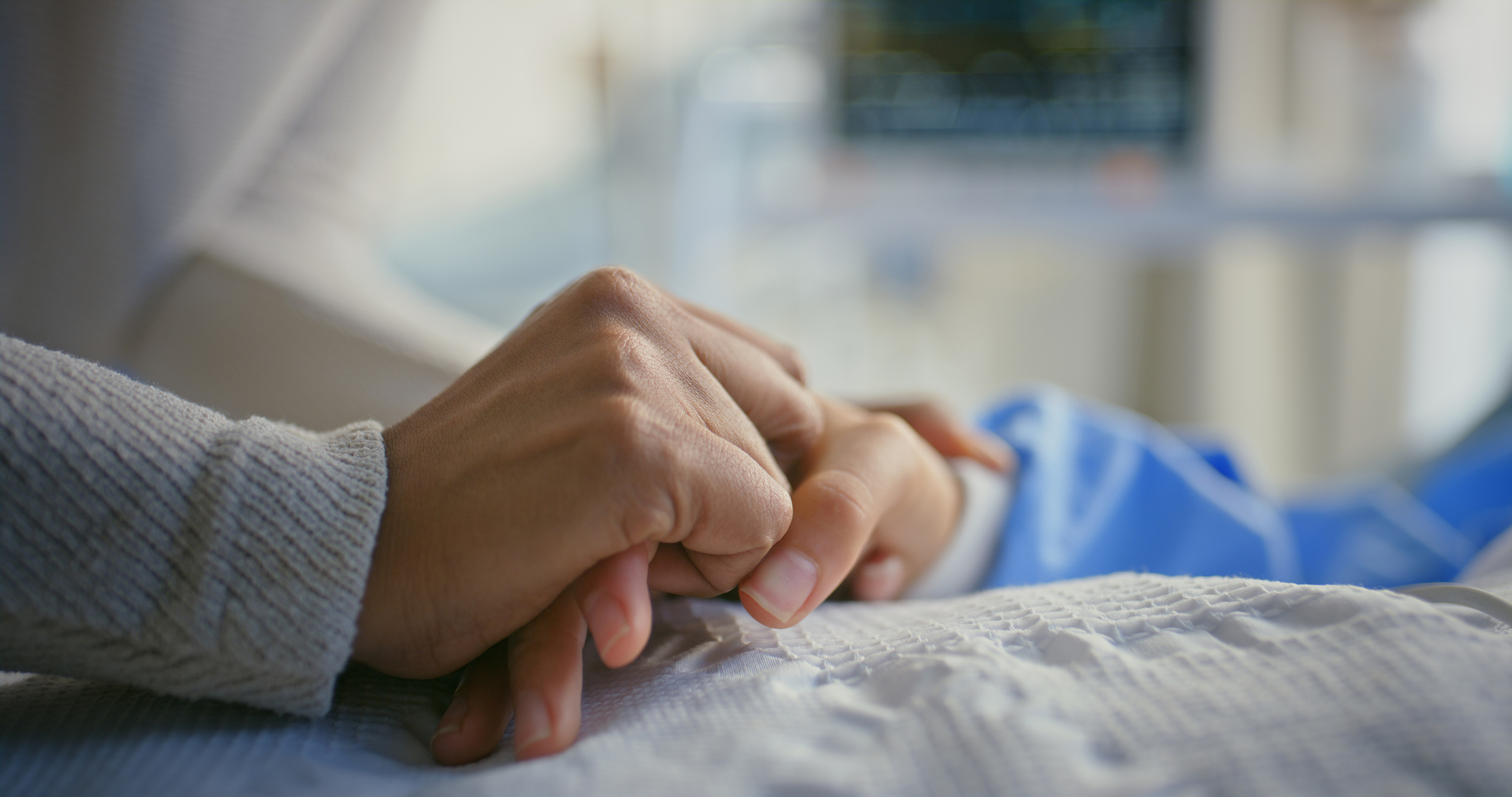 Older women holding hands praying